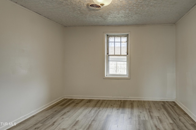 unfurnished room featuring a textured ceiling and light wood-type flooring