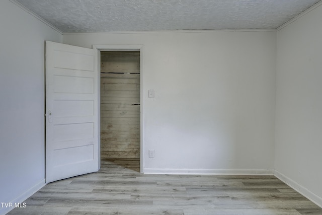 unfurnished bedroom with light hardwood / wood-style floors and a textured ceiling