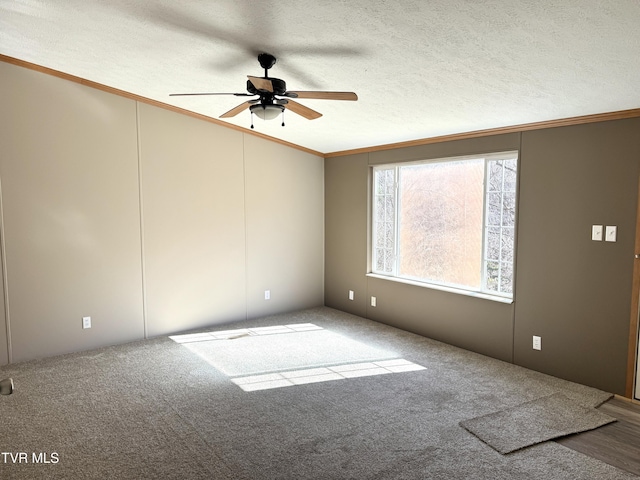 unfurnished room featuring ceiling fan, ornamental molding, a textured ceiling, and carpet flooring