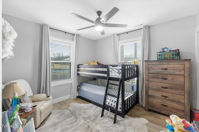 bedroom with light hardwood / wood-style floors and ceiling fan