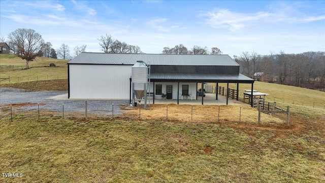 view of front facade with a rural view and a front yard