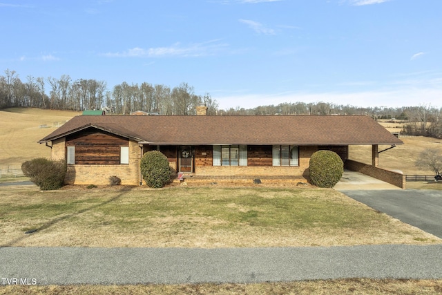 ranch-style house with a carport and a front yard