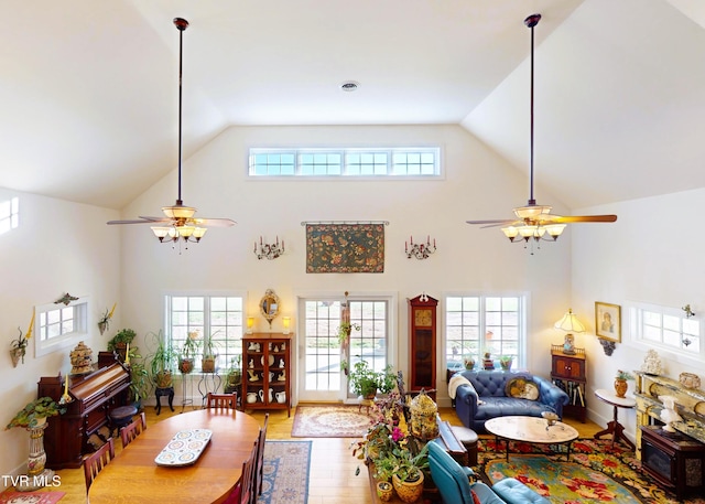 living room featuring wood-type flooring, a healthy amount of sunlight, and ceiling fan