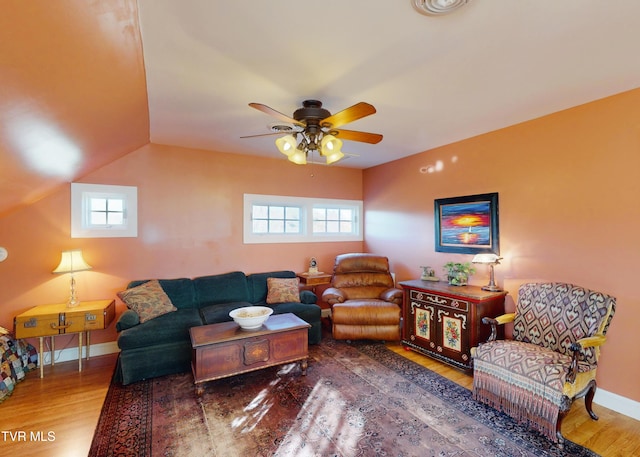 living room with wood-type flooring and ceiling fan