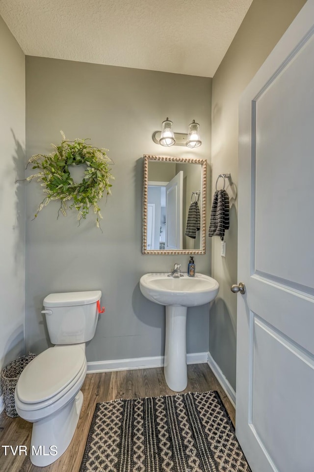 6758 Wildlife Cir, Piney Flats, TN 37686 - bathroom with wood-type flooring, toilet, and a textured ceiling