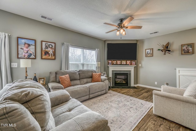 6758 Wildlife Cir, Piney Flats, TN 37686 - living room featuring dark wood-type flooring, a textured ceiling, and ceiling fan