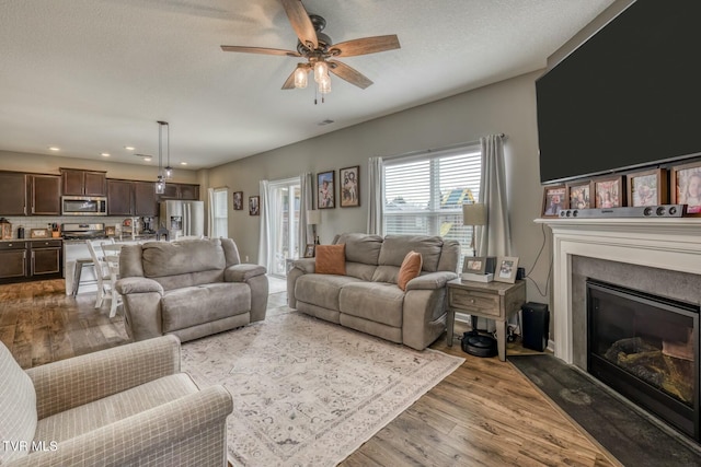 6758 Wildlife Cir, Piney Flats, TN 37686 - living room with ceiling fan, hardwood / wood-style flooring, and a textured ceiling