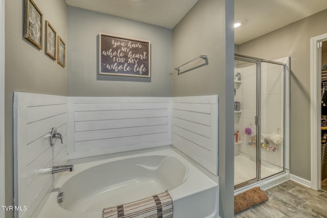 6758 Wildlife Cir, Piney Flats, TN 37686 - bathroom featuring wood-type flooring, plus walk in shower, and a textured ceiling