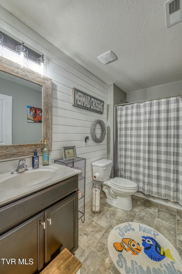 6758 Wildlife Cir, Piney Flats, TN 37686 - bathroom with vanity, wood walls, a textured ceiling, and toilet