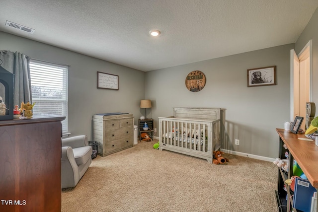 6758 Wildlife Cir, Piney Flats, TN 37686 - bedroom featuring a crib, light carpet, and a textured ceiling