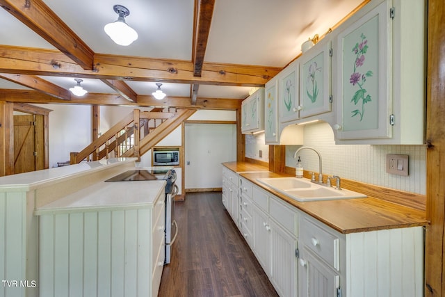 kitchen with tasteful backsplash, beamed ceiling, sink, stainless steel appliances, and dark wood-type flooring