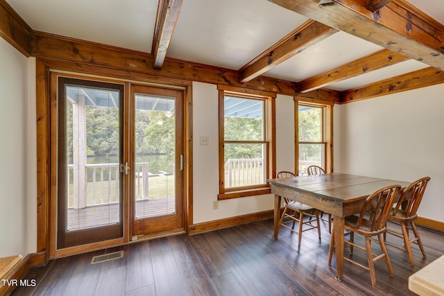 dining room featuring beamed ceiling and dark hardwood / wood-style flooring