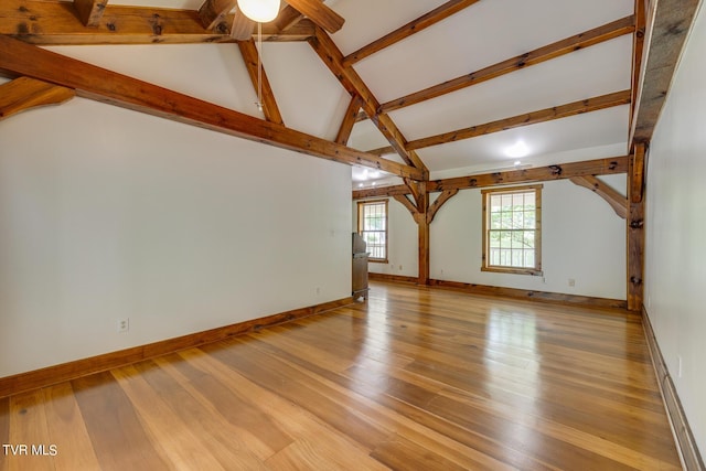 interior space featuring beam ceiling, high vaulted ceiling, and light wood-type flooring