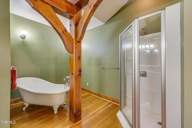 bathroom featuring lofted ceiling, wood-type flooring, and shower with separate bathtub