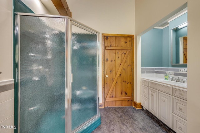 bathroom with vanity and a shower with door