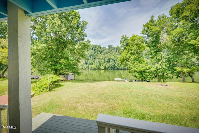 view of yard with a water view and a shed