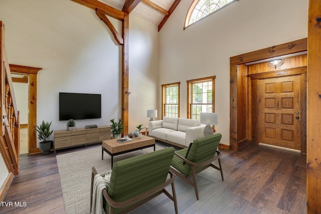 living room with high vaulted ceiling, dark hardwood / wood-style floors, and beam ceiling