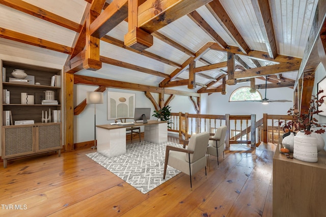 living area with vaulted ceiling with beams and light hardwood / wood-style floors