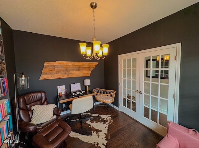 living area featuring dark wood-type flooring, french doors, and a chandelier