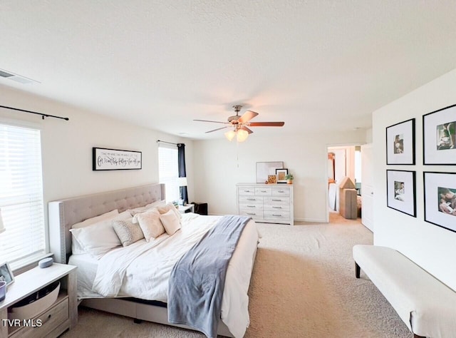 bedroom featuring light carpet and ceiling fan