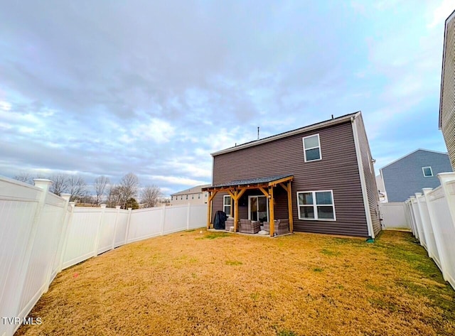 back of property featuring a patio area and a lawn