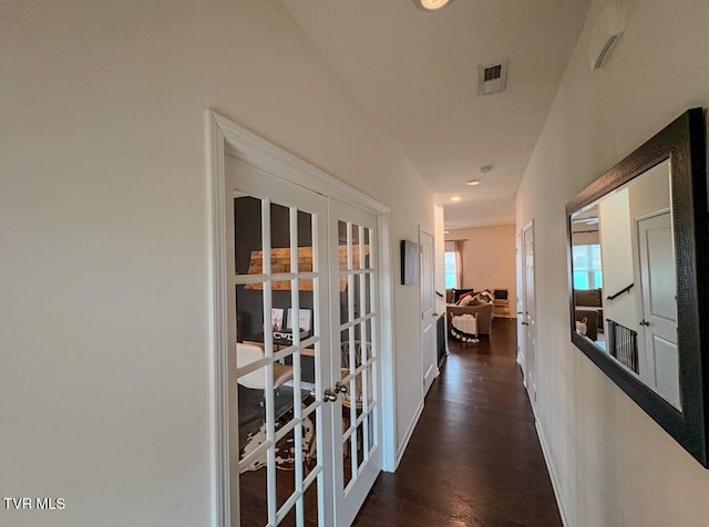 corridor featuring dark hardwood / wood-style floors and french doors