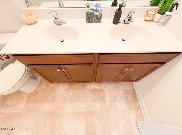 bathroom with vanity, tile patterned floors, and toilet