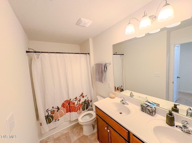 full bathroom with vanity, toilet, shower / bath combo with shower curtain, and a textured ceiling