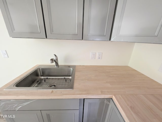 kitchen with gray cabinetry and sink