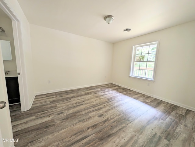 empty room with dark hardwood / wood-style floors