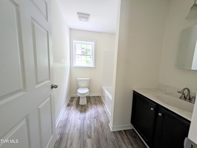 bathroom with vanity, hardwood / wood-style floors, and toilet