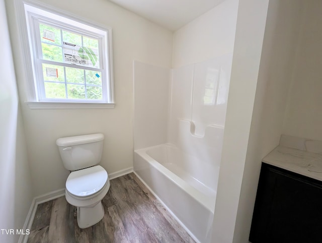 full bathroom featuring vanity, hardwood / wood-style floors,  shower combination, and toilet