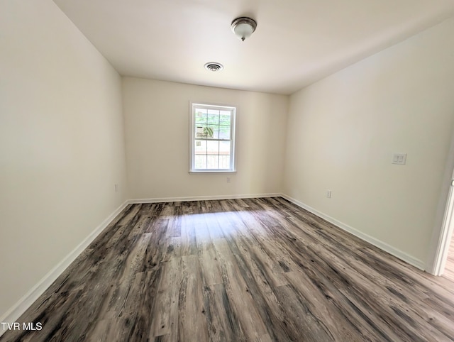 empty room with hardwood / wood-style flooring