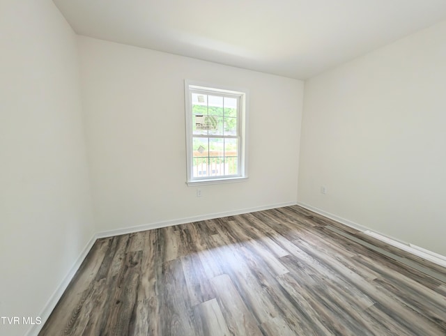 unfurnished room with hardwood / wood-style flooring