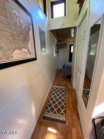 corridor with a high ceiling and hardwood / wood-style floors