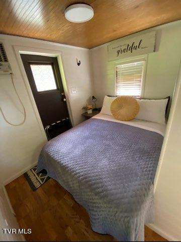 bedroom featuring hardwood / wood-style floors and wood ceiling