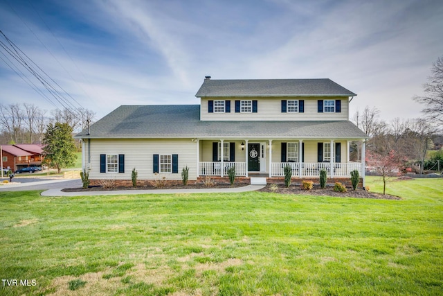 view of front of property with a porch and a front lawn