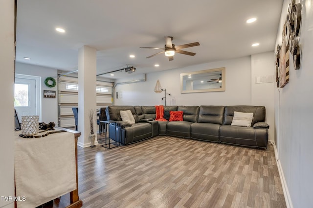 living room with hardwood / wood-style flooring and ceiling fan