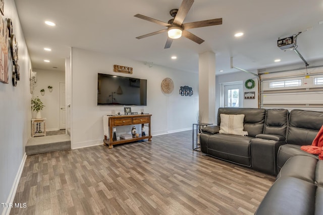 living room with hardwood / wood-style flooring and ceiling fan