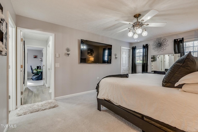 bedroom with light carpet, a closet, and ceiling fan