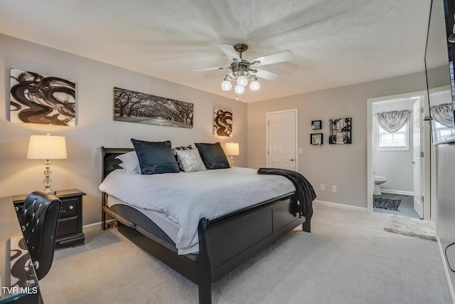 carpeted bedroom featuring ensuite bathroom, ceiling fan, and a textured ceiling