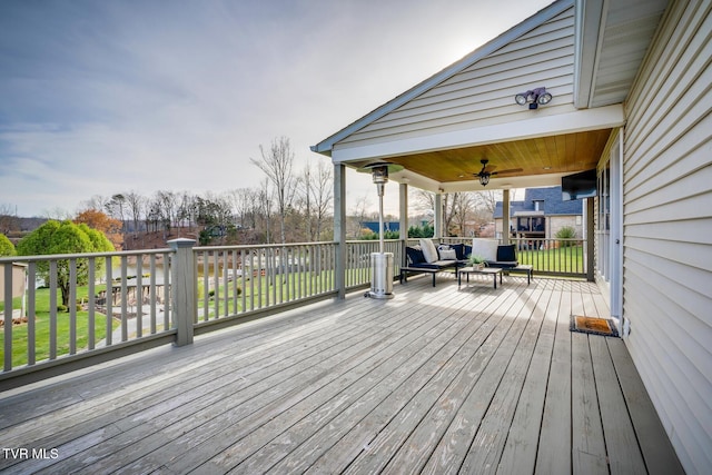 wooden deck with ceiling fan and an outdoor hangout area