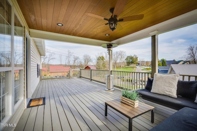 deck featuring ceiling fan and outdoor lounge area