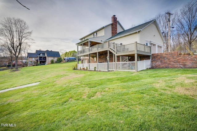 back of property with a garage and a lawn