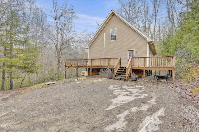 rear view of house featuring a deck