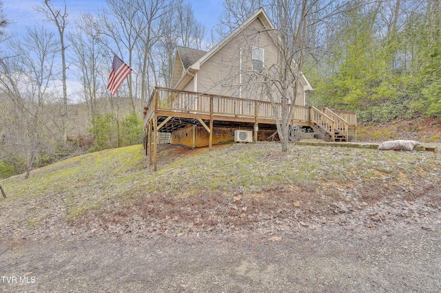 rear view of property featuring a wooden deck