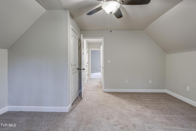 additional living space with vaulted ceiling, light carpet, and ceiling fan