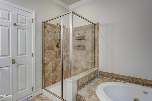 bathroom featuring crown molding and separate shower and tub