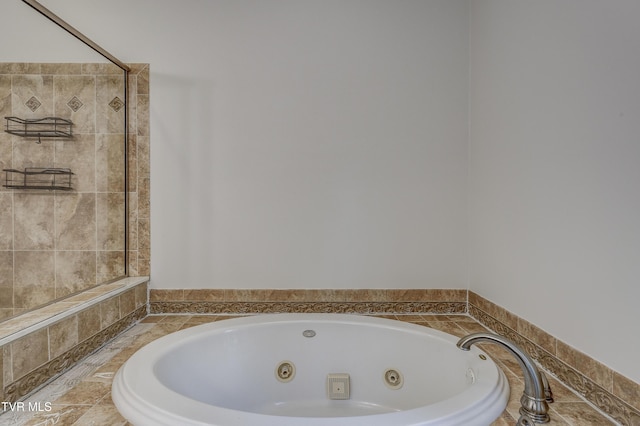 bathroom featuring tiled tub