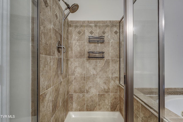 bathroom featuring separate shower and tub